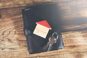 key and house model on wallet