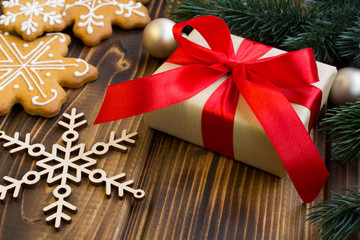 Christmas gift and cookies on the wooden background