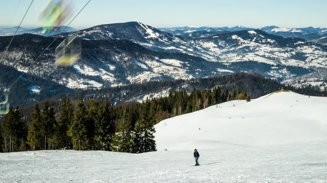 Ski lift at ski resort in sunny Carpatian mountains, time lapse