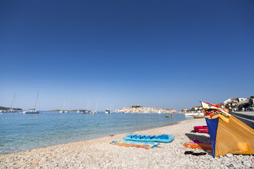 Fototapeta premium Beach by the sea in summer boats Primosten, Croatia