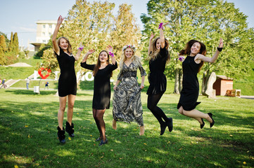 Five girls wear on black jumping at hen party.