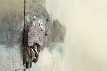 Padlock on metal door in front, copy space