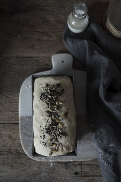 Bread dough proofing on a rustick kitchen table