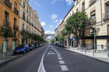 Street in Madrid downtown with Segovia bridge at the end