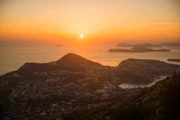 Sunset on the Adriatic sea with layers mountains on the horizon. Beautiful panoramic view of Dubrovnik, Croatia.