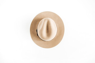 Pale pastel beige hat on white background. Flat lay, top view.