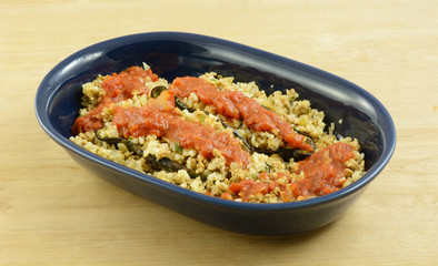 Chiles rellenos casserole with poblano pepper and ground turkey meat in blue bowl