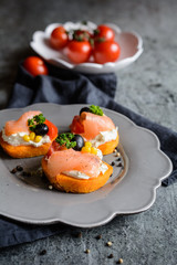 Sweet potato slices topped with cream cheese, smoked salmon, olives and corn