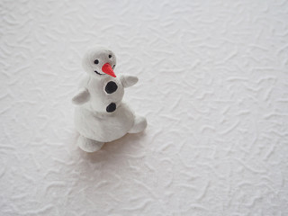 Fun toy snowman on a light background
