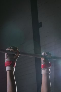 Male Gymnast Hands Practicing Gymnastics On The Horizontal Bar