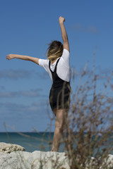 Beautiful young woman enjoying nature by the sea