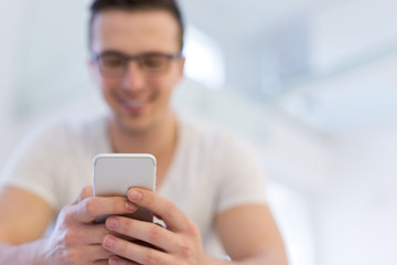 young man using a mobile phone  at home