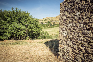 Stone wall of an old house and landscape view