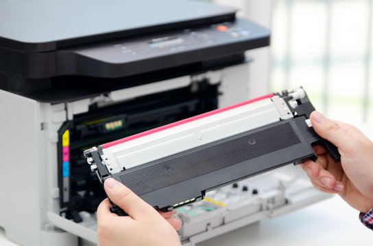 Man replacing toner in laser printer