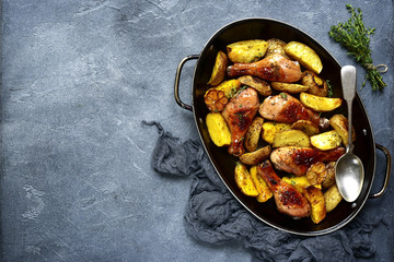 Chicken legs baked with potato.Top view.