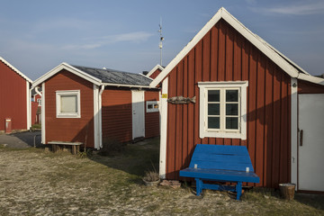 Small wooden cabins for yacht's men in a Swedish coast  - obrazy, fototapety, plakaty