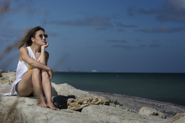 Fototapeta na wymiar Beautiful young woman enjoying nature by the sea