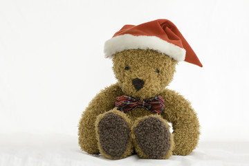 Teddy Bear with Christmas Hat sitting on white background