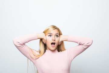 Fototapeta premium picture of woman with hands on ears on white background