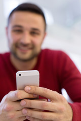 young man using a mobile phone  at home