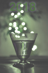 Light drink new year abstract in crystal glass background with year 2018 in new pantone colors green, purple, blue