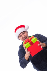 Handsome man offering a christmas gift isolated on white background