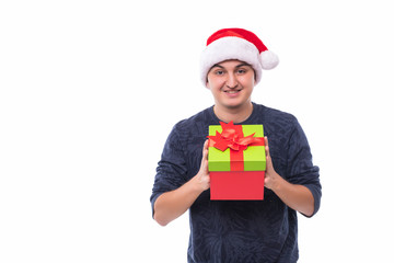 Handsome man offering a christmas gift isolated on white background