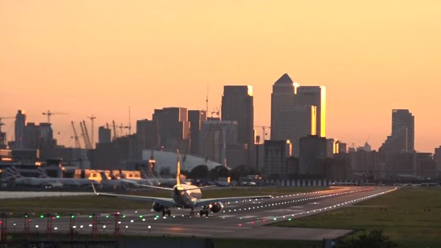 UK September 2017 - a plane takes off at City Airport during sunset in London.