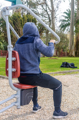 young man doing exercise in a park