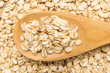 Obraz na płótnie Canvas Oat cereal grain. Grains in wooden spoon. Close up.