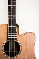 Closeup of acoustic guitar hanging on wall