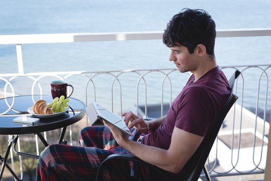 Man using digital tablet on terrace