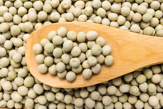 Pea. Grains in wooden spoon. Close up.
