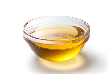 Fresh peanut oil in a glass bowl on white background