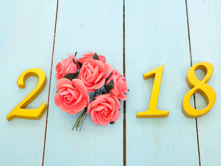 a new year 2018 banner and a bouquet of roses