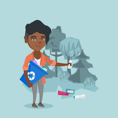 Young african woman collecting garbage in a recycle bin in the forest