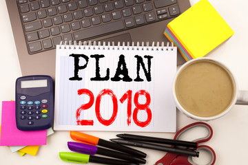 Word writing Plan 2018 in the office with surroundings such as laptop, marker, pen, stationery, coffee. Business concept for Strategy Action Plan 2018 Workshop white background with copy space