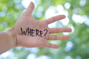 Concept Photo Of A Handwriting Word "WHERE?" On The Left Hand With Blurry Background