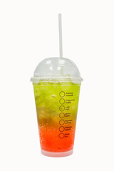 Green and red italian soda in the plastic cup ice water