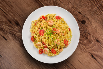 Shrimp spaghetti plate on wooden background