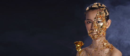 Gold Leaf High fashion style on Asian Woman Face dark mystery look