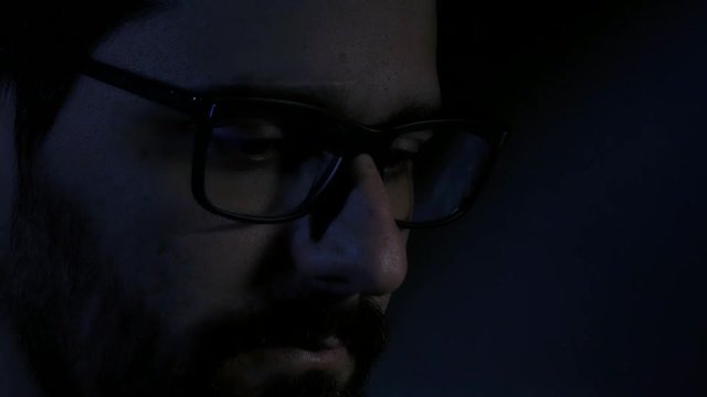 Lateral close up of hacker wearing glasses
