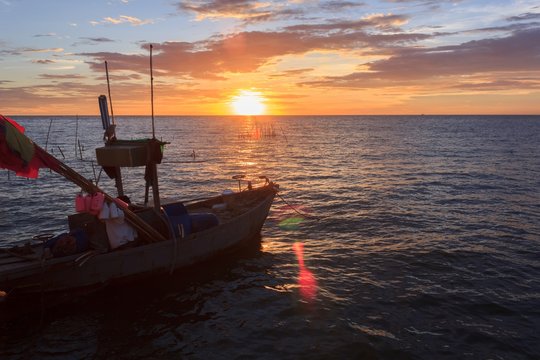 Fishing boat in the sea at sunset.