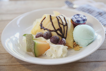 crepe cake with milk ice cream and watermelon melon grapes on wood background