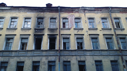 An old abandoned building and traces of fire - soot on the walls near the windows