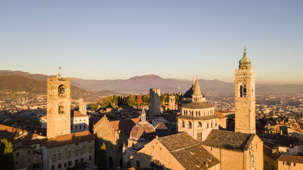 Fototapeta na wymiar Bergamo, Italy. Drone aerial view of the Old city. One of the beautiful city in Italy. Landscape on the city center and the historical buildings during the sunset