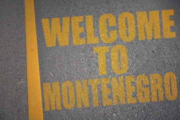 asphalt road with text welcome to montenegro near yellow line.
