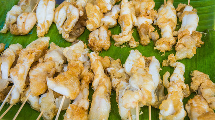 Egg of squid grilled  on green banana leaf, Chanthaburi, Thailand.