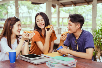 Students asian group together eating pizza in breaking time early next study class having fun and enjoy party italian food slice with cheese delicious at university outdoor
