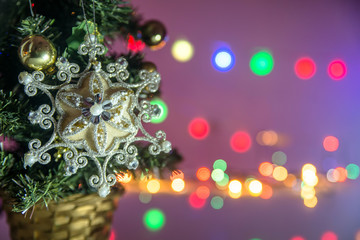 Fototapeta na wymiar Christmas toy in the form of snowflakes on the background illumination 